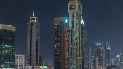 Fototapeta na wymiar Dubai International Financial district aerial night timelapse. Panoramic view of business and financial office towers.