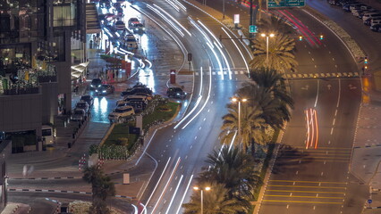Fototapeta na wymiar Skyline view of traffic on Al Saada street near DIFC district night timelapse in Dubai, UAE.