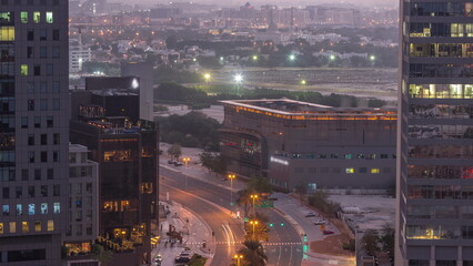 Skyline view of traffic on Al Saada street near DIFC district night to day timelapse in Dubai, UAE.