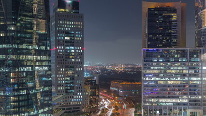 Dubai International Financial district aerial night timelapse. Panoramic view of business and financial office towers.