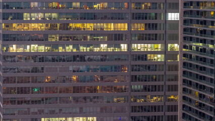 Fototapeta na wymiar Windows of office buildings night to day timelapse, the light from the windows of houses