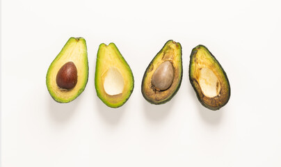 Ripe and spoiled rotten fruit vegetables avocado in a cut, white background, copy space