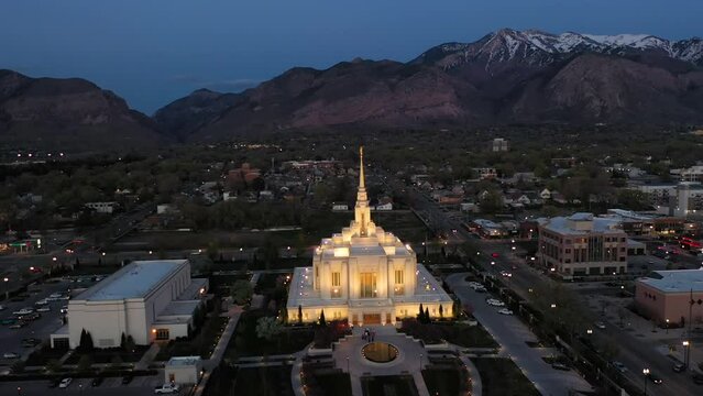 Latter-day Saints mormon temple in Ogden Utah. Drone orbit around temple with snow-capped Wasatch Mountains in background.