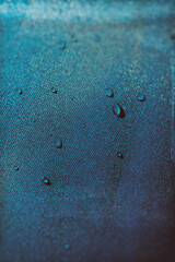 blue-green surface with water drops, blurry image
