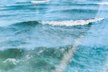 sea surface with waves and foam blue-green fragment, blurry image