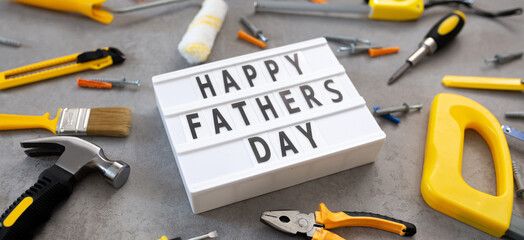 Father's Day lightbox message with tools for repair saw nippers hammer . top view flat lay. I love dad