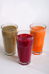 Natural fresh juices of pumpkin, beets and apples isolated on white background.