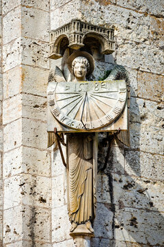 Statue of angel holding sundial at Cathedral Our Lady of Chartres, France - one of the finest examples of French Gothic architecture, constructed during the 13th century.