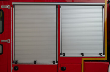 Fire engine roller shutters or roll-up doors. Fire brigade truck side view with the rollers down.