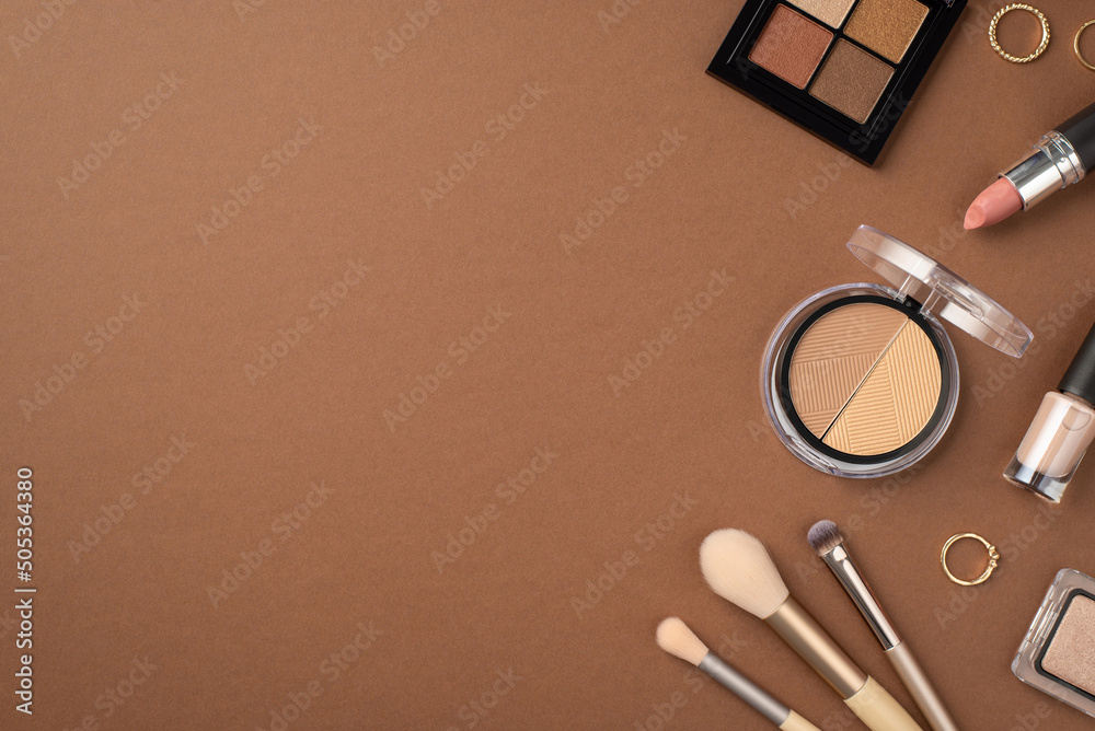 Wall mural make-up concept. top view photo of eyeshadow and contouring palettes nail polish gold rings makeup b