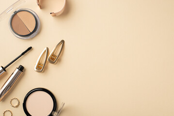 Makeup concept. Top view photo of contouring palette gold rings bracelet two barrettes mascara and compact powder on pastel beige background with copyspace