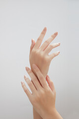 A front view of hand posing in white background for cosmetic advertising 