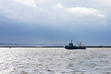 Fishing ship returns to port, fish catch, storm, bad weather