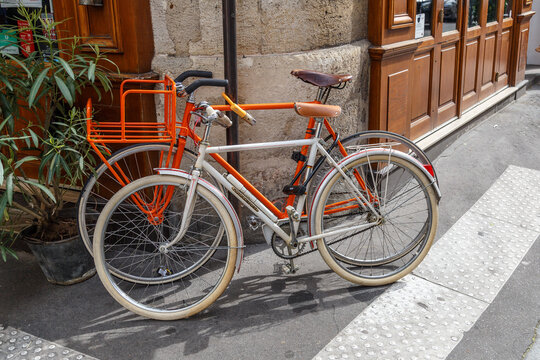 Paris, France, April 1, 2017: Old style bicycle in front of the Paris restaurant. Typical French street in Montmartre district with small houses are located cafes, restaurants and art galleries