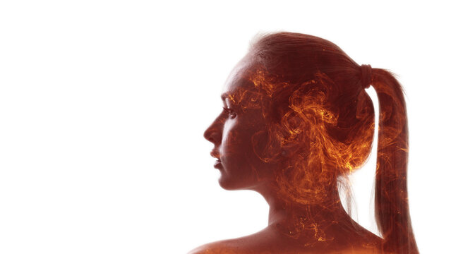 Passion energy. Emotional anxiety. Fear frustration. Double exposure profile silhouette of disturbed woman head on orange red fire flames isolated on white copy space.