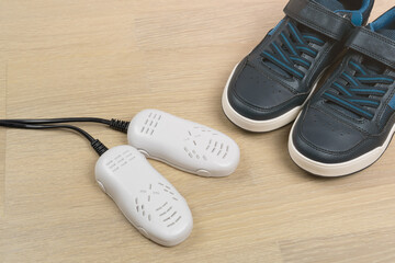 Small electric ultraviolet shoe dryer for children footwear.