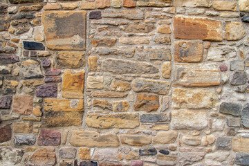 Beautiful old European Medieval era stone wall abstract  texture background, with bricked in window
