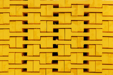 New yellow wooden formwork stacked in a warehouse in large stack. Materials for the construction and erection of concrete structures. wooden formwork made of plywood.