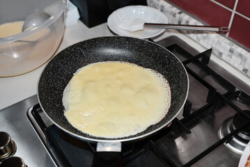 Frying delicious crepe on pan in kitchen