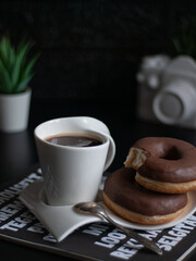 Cup of morning coffee with chocolate donuts