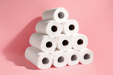 Many rolls of paper towels on pink background