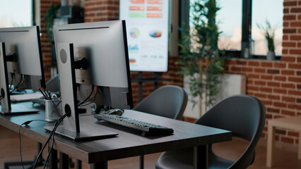 No people in customer support service office with computers, space prepared to talk to clients at helpline call center. Nobody in workplace to give telemarketing and telework assistance.