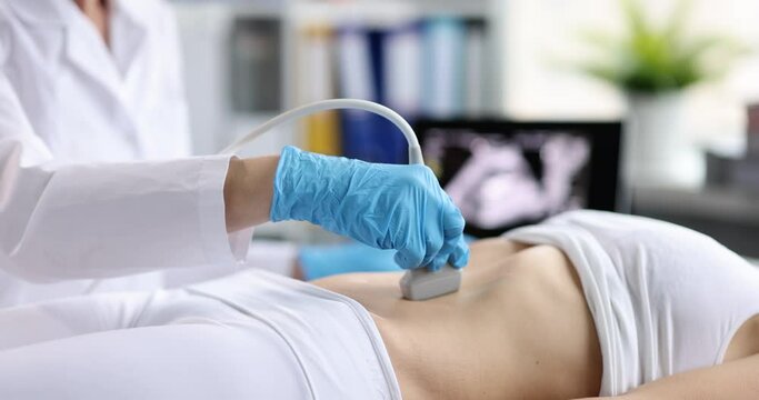 Doctor doing ultrasound examination of internal organs closeup 4k movie slow motion