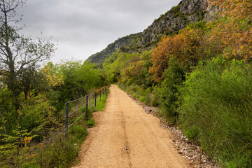 Fototapeta na wymiar Turist's road based in Konavle region near Dubrovnik. The road along the slope of the mountain above the valley.