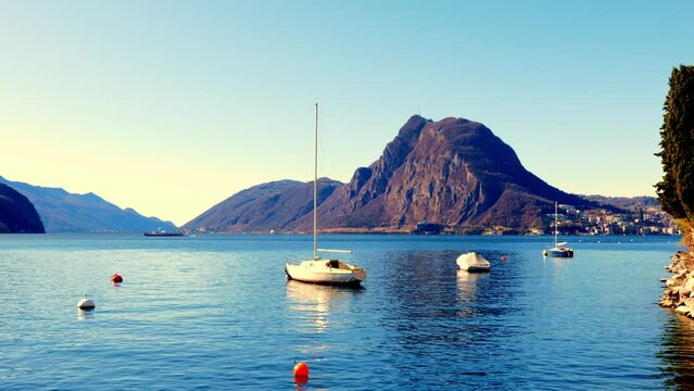 Waterfront on Lake Lugano with Mountain Peak Monte Bre and Trees in a Sunny Day with Clear Sky in Lugano Ticino, Switzerland.