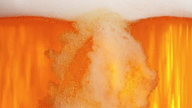 Super Slow Motion Shot of Pouring Fresh Beer into Glass with Foam at 1000fps.