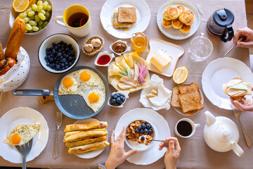 Breakfast on the table top view.Food on the table top view.Muesli with berries. Fried eggs. Meal day. Buffet. Delicious breakfast. Croissants for breakfast. Lots of food top view. Oatmeal. Muesli with