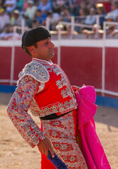 a Spanish bullfighter practices with his capote moments before the bullfight