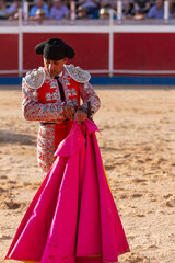 long shot of a bullfighter keeping his knife after the bullfight