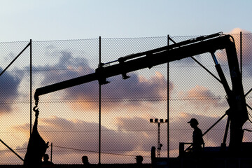 a crane operator moves a dead bull for quartering after a bullfight