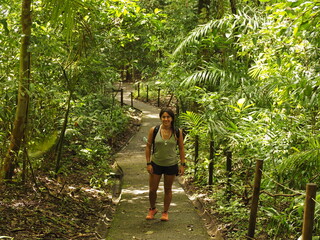 Naklejka na ściany i meble YOUNG WOMAN HIKING IN THE NATIONAL PARK OF MANUEL ANTONIO IN COSTA RICA