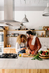 Couple preparing food in kitchen. - 505387191