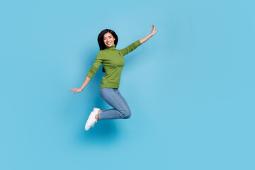Full length body size view of attractive cheerful funky girl jumping rest having fun shop isolated over bright blue color background