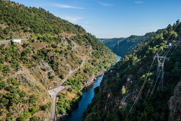 Fototapeta na wymiar Canyon with rocks and vegetation and river Zêzere, aerial view on Cabril dam with bridge in the background, Pedrogão Grande PORTUGAL