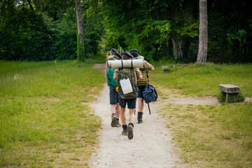 young scouts hiking in the countryside - obrazy, fototapety, plakaty