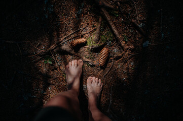 Bare feet of woman standing barefoot outdoors in nature, grounding concept.
