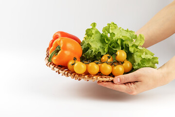 hand holding a bowl of vegetables