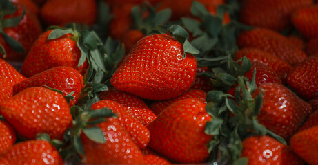 Close-up of a selective focus of ripe strawberries on the counter. Strawberries are sold in boxes as a healthy food. Top view of delicious, fresh, juicy strawberries, just picked. Juicy berries.