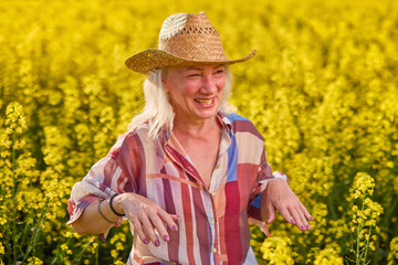 Portrait of a middle-aged woman in the rapeseed chain.