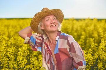 Portrait of a middle-aged woman in the rapeseed chain.