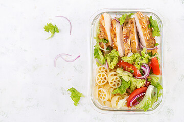 Lunchbox. Lunch box with grilled chicken fillet and pasta salad with fresh vegetables. Top view,...