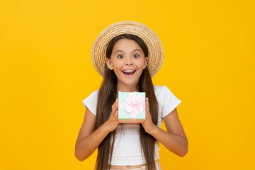 amazed teen kid hold present box on yellow background - obrazy, fototapety, plakaty