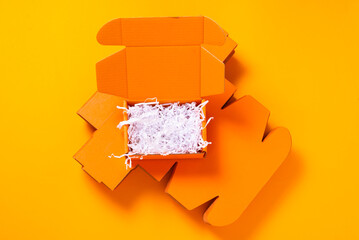 Orange cardboard box with white shredded paper filler