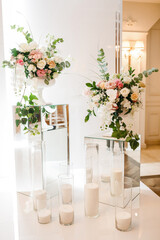 Elegant wedding decorations, mirrored cubes with flowers and candles.