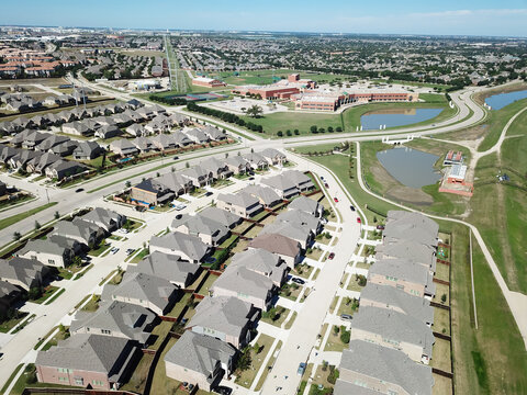New development residential area with row of two story single family houses near school district in North Texas, America