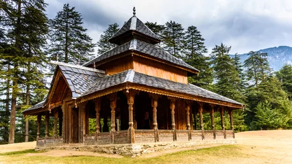 Foto auf Acrylglas Himalaya Shangchul mahadev temple in the meadow of Shahgarh, surrounded by Deodar Tree and Himalayas mountains in Sainj Valley, Great Himalayan National Park, Himachal Pradesh, India